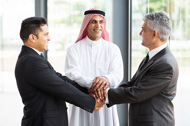 successful multicultural global business team hands together