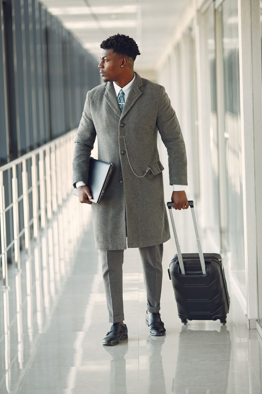 Businessman with a suitcase walking through an airport
