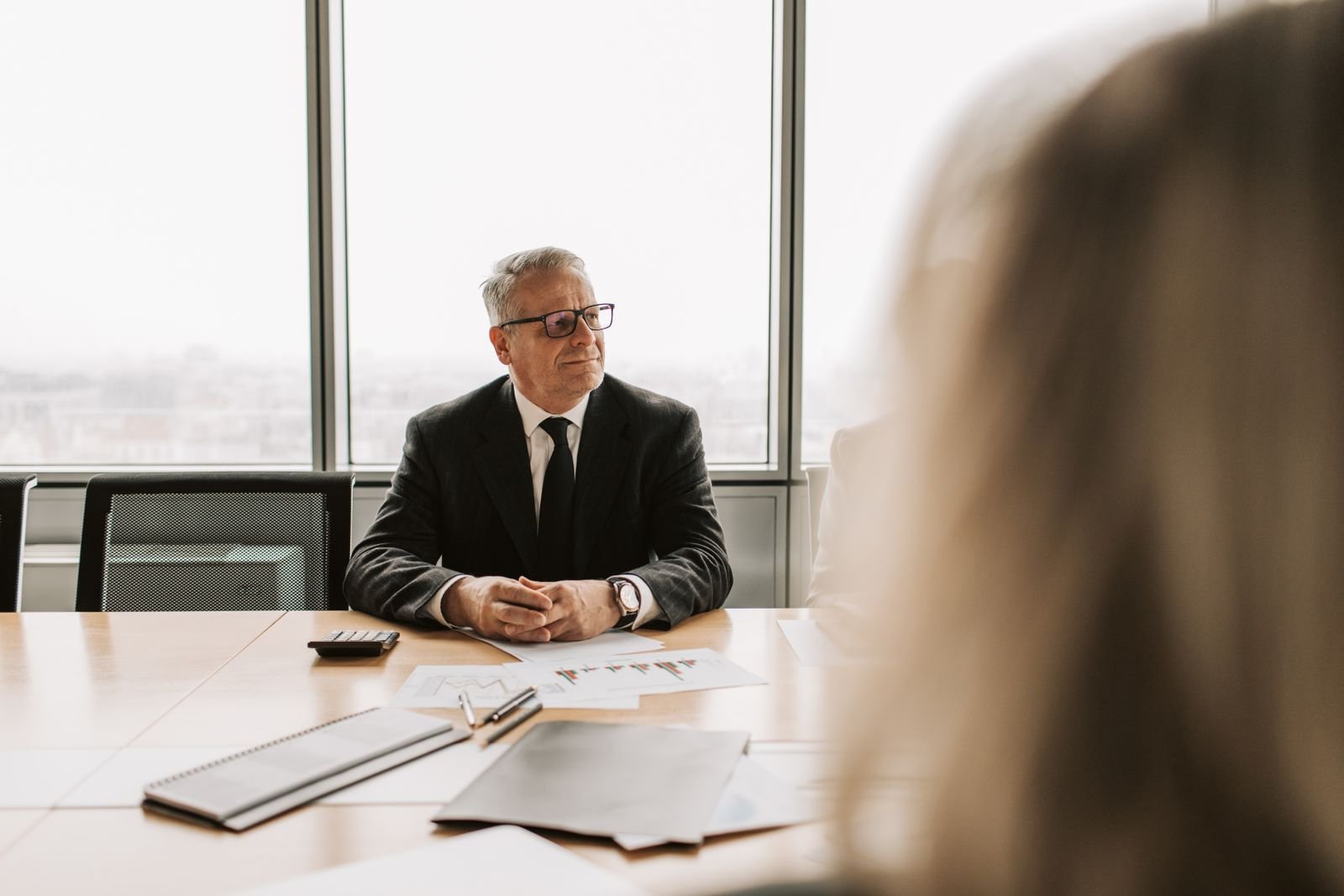 Professional advisor in a suit at his office desk